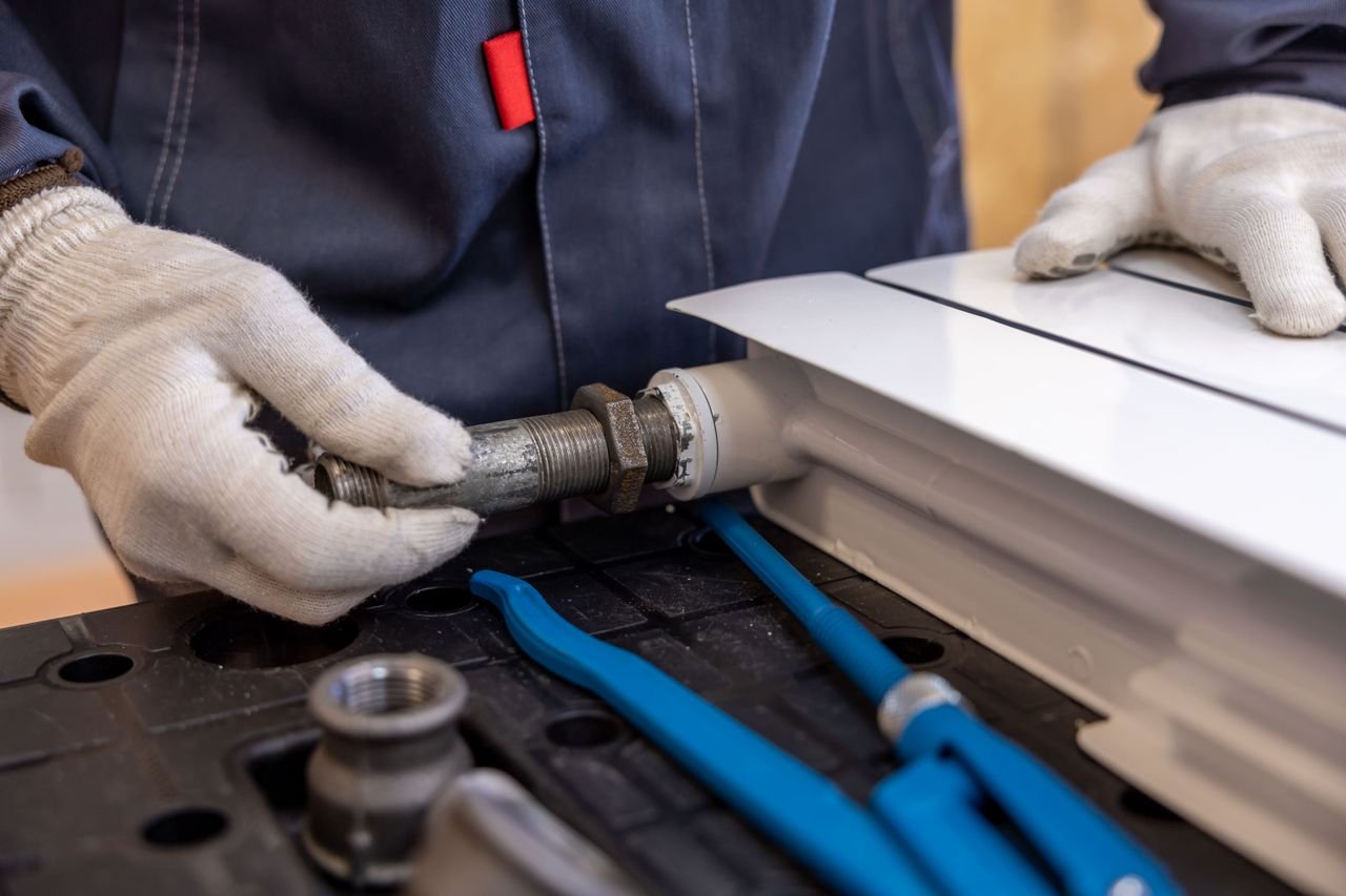 Licensed Portland emergency plumber repairing a pipe